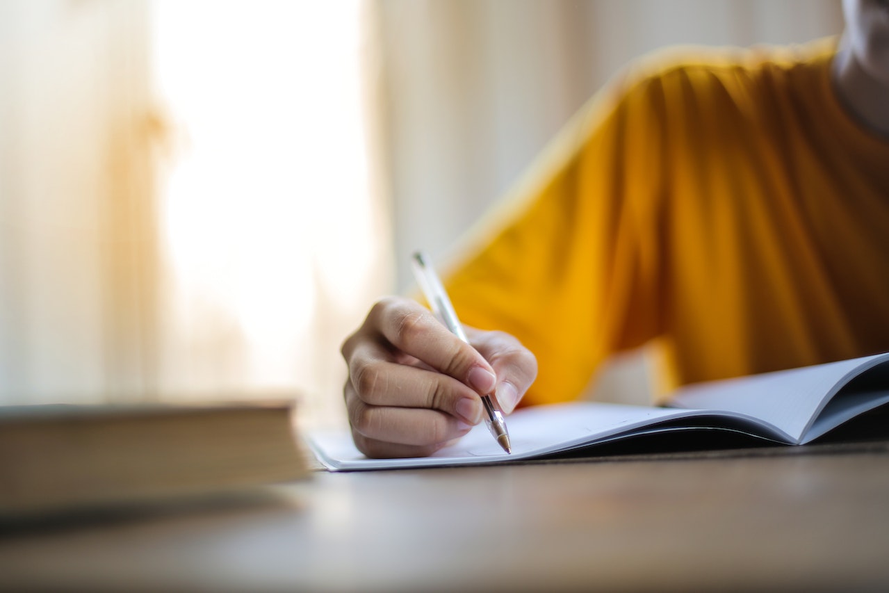 A person writes in a journal 