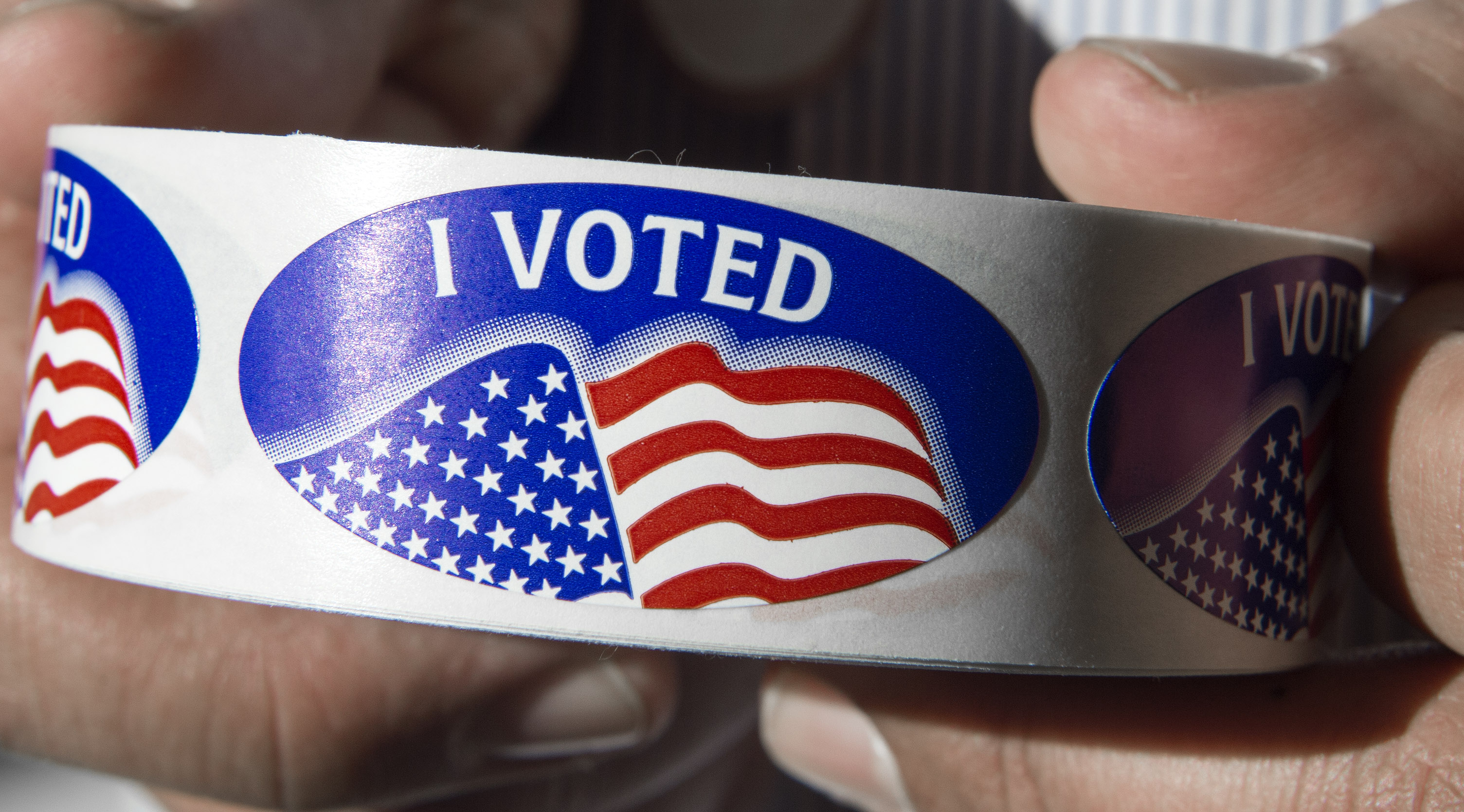 An election official holds a roll of the "I voted" stickers at Centreville High School in Centreville, Virginia March 1, 2016, during the Super Tuesday primary voting. Voters in a dozen states will take part in "Super Tuesday" -- a series of primaries and caucuses in states ranging from Alaska to Virginia, with Virginia the first to open its polling stations at 6:00 am (1100 GMT). / AFP / PAUL J. RICHARDS (Photo credit should read PAUL J. RICHARDS/AFP/Getty Images)