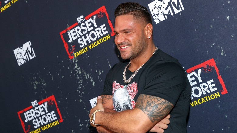 Ronni Magro poses with his arms crossed.