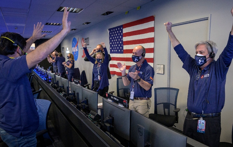 Members of NASA's Perseverance rover team react in mission control after receiving confirmation the spacecraft successfully touched down on Mars