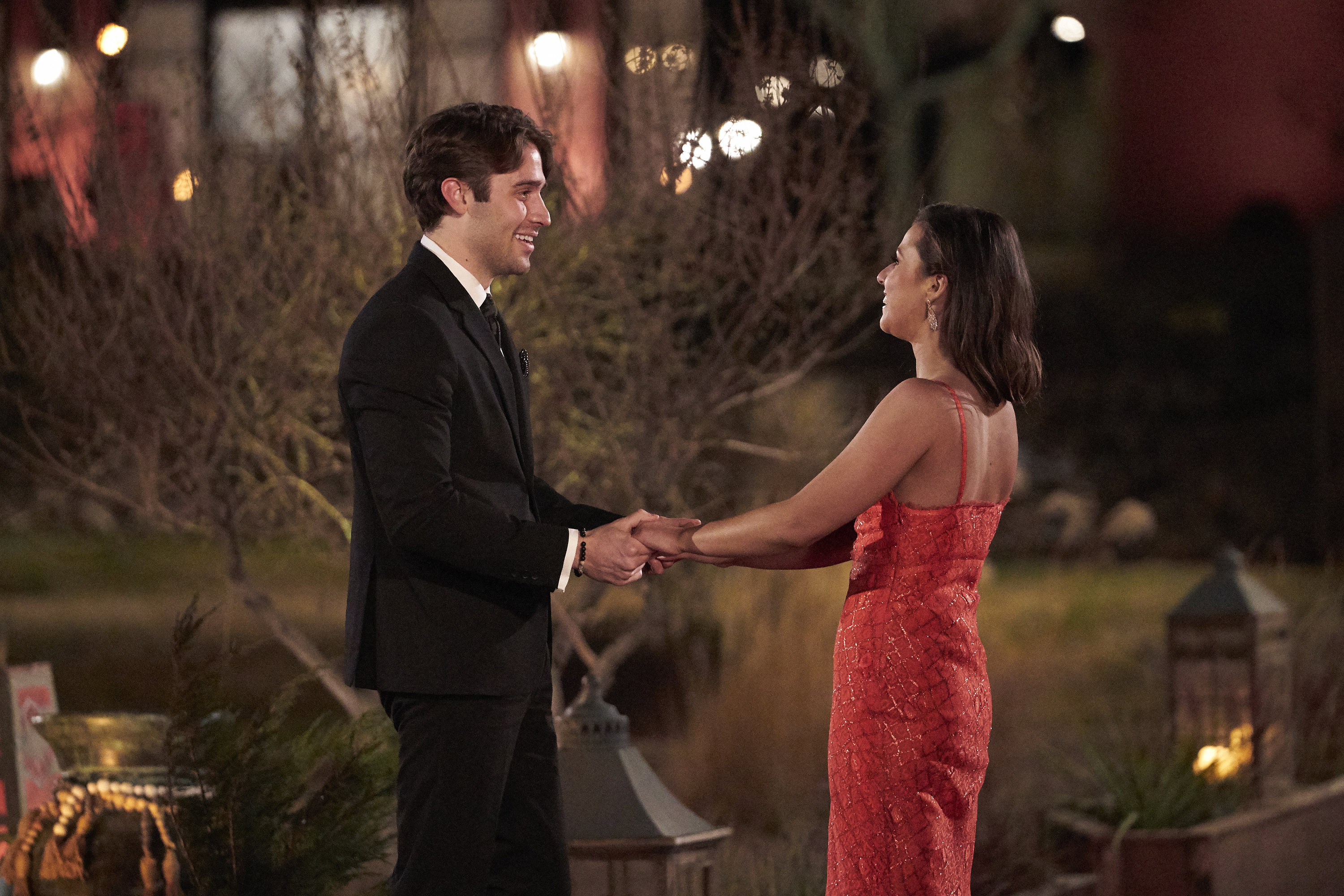 Katie Thurston and Greg holding hands.