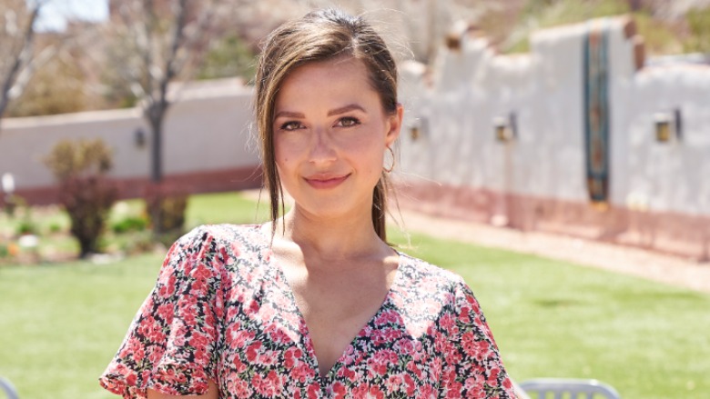 Katie Thurston in a pink floral dress.