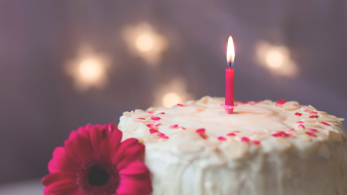 Birthday cake with lit candle