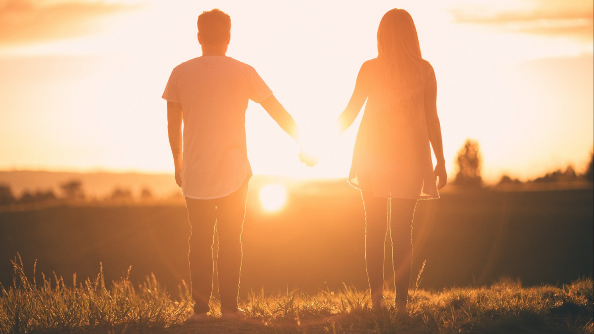 A couple holding hands.