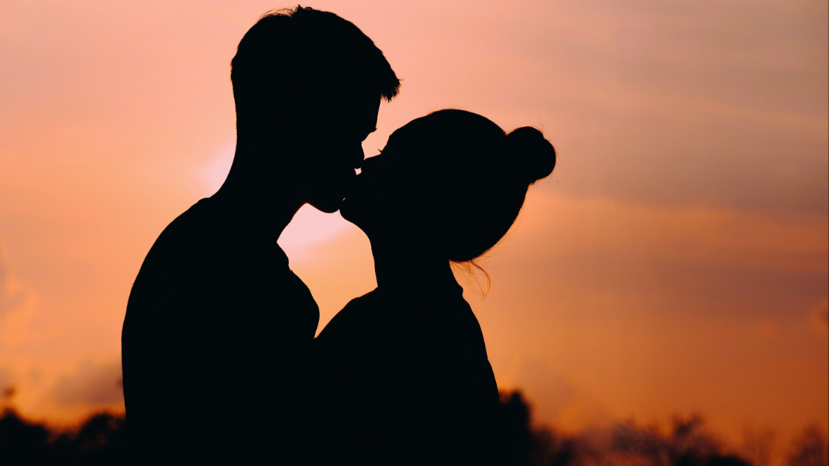 A couple kissing.