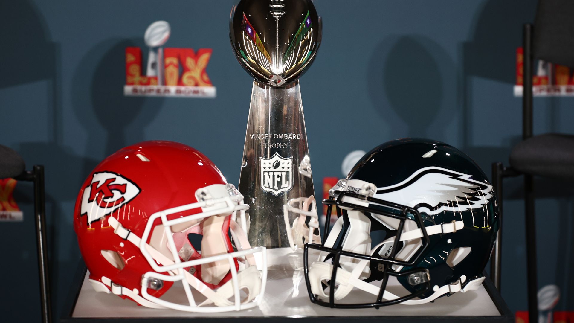 Chiefs and Eagles helmets with the Super Bowl Trophy ahead of their 2025 rematch.
