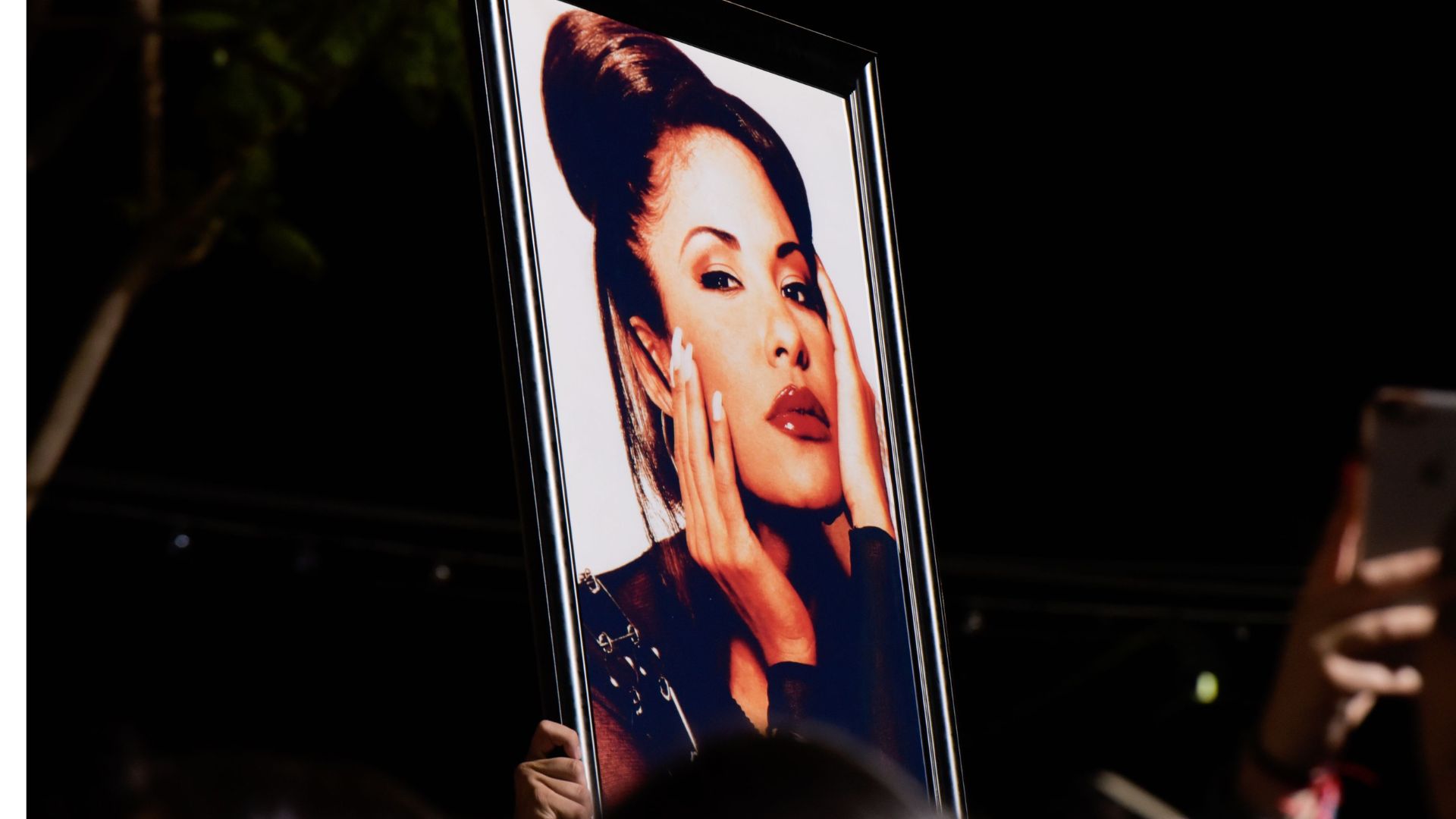 Fans hold a photo of Selena during the ceremony honoring the singer with a Star on the Hollywood Walk of Fame on November 3, 2017.