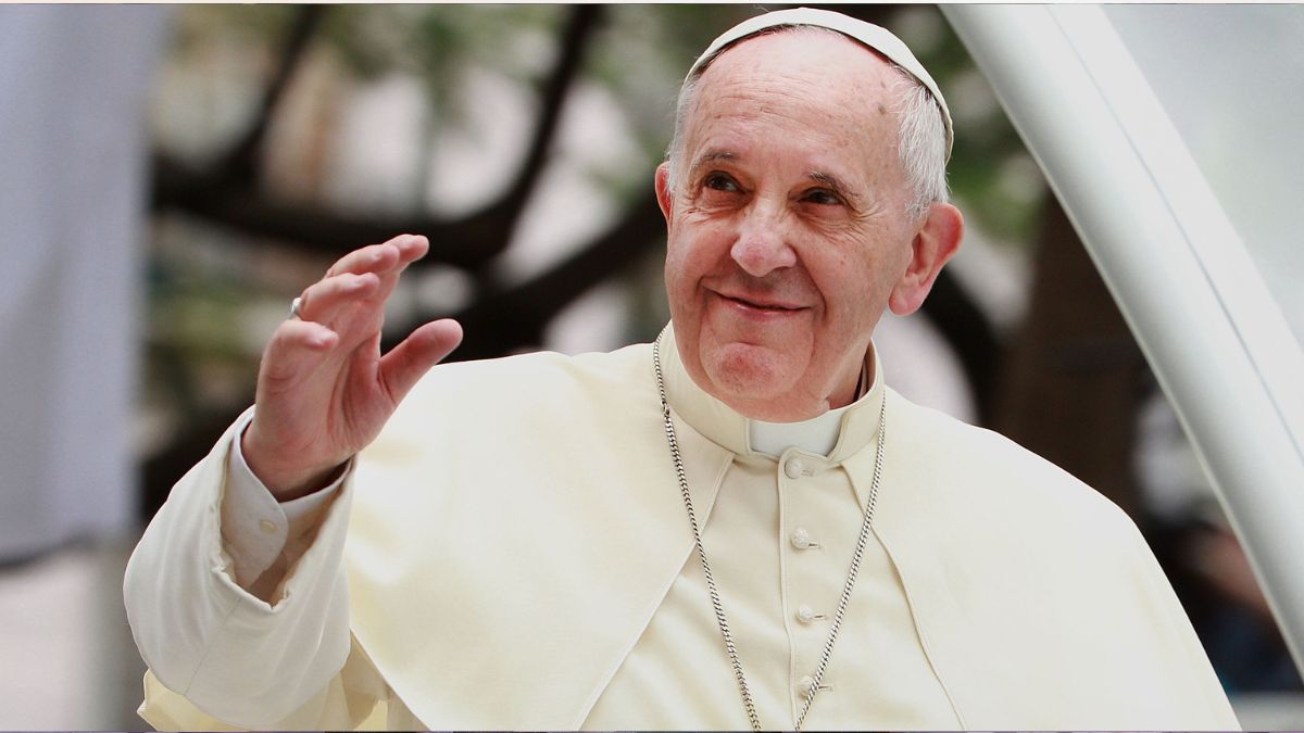 Pope Francis waves to thousands of followers as he arrives at the Manila Cathedral