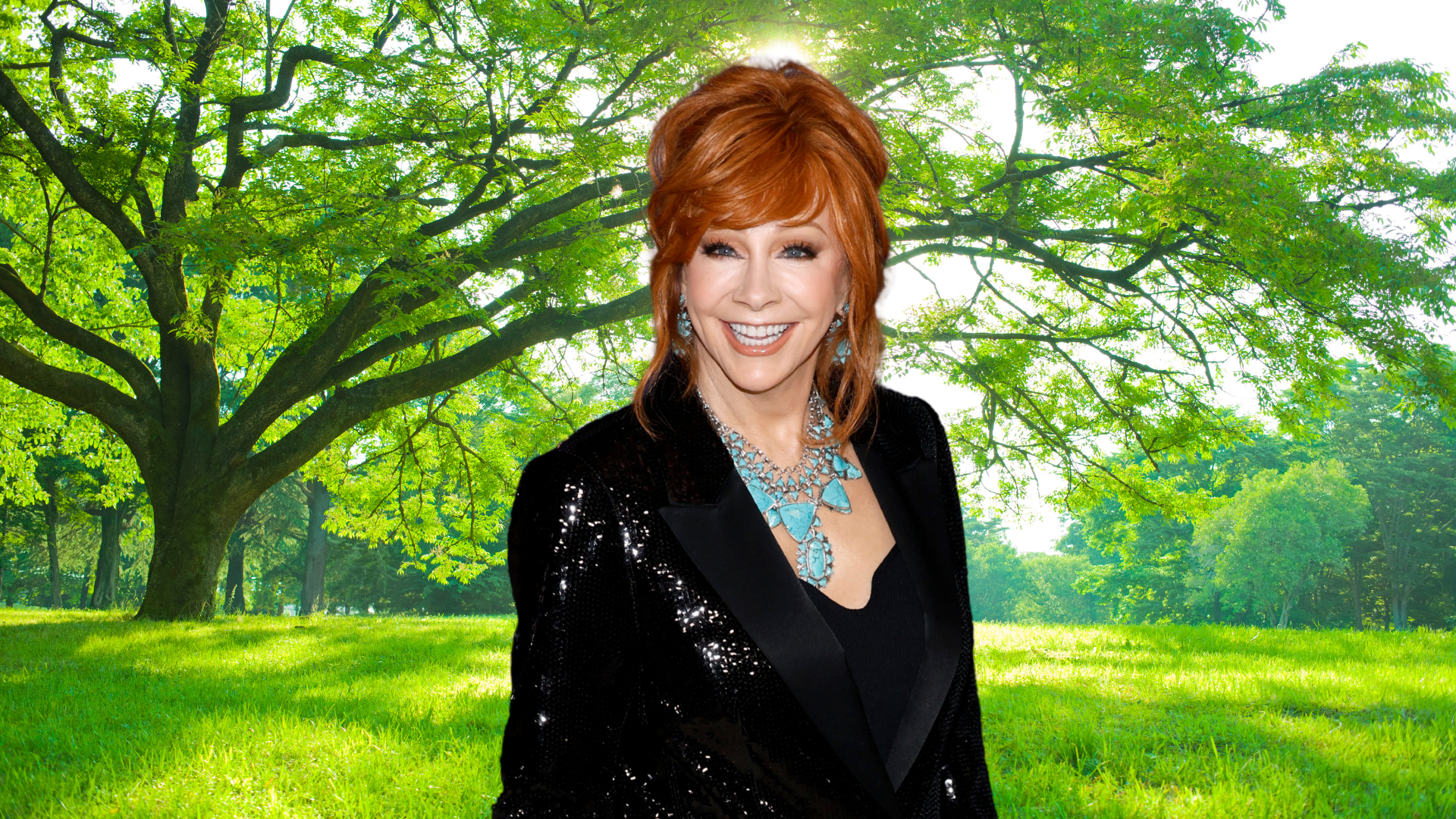 Reba McEntire smiling in front of a tree