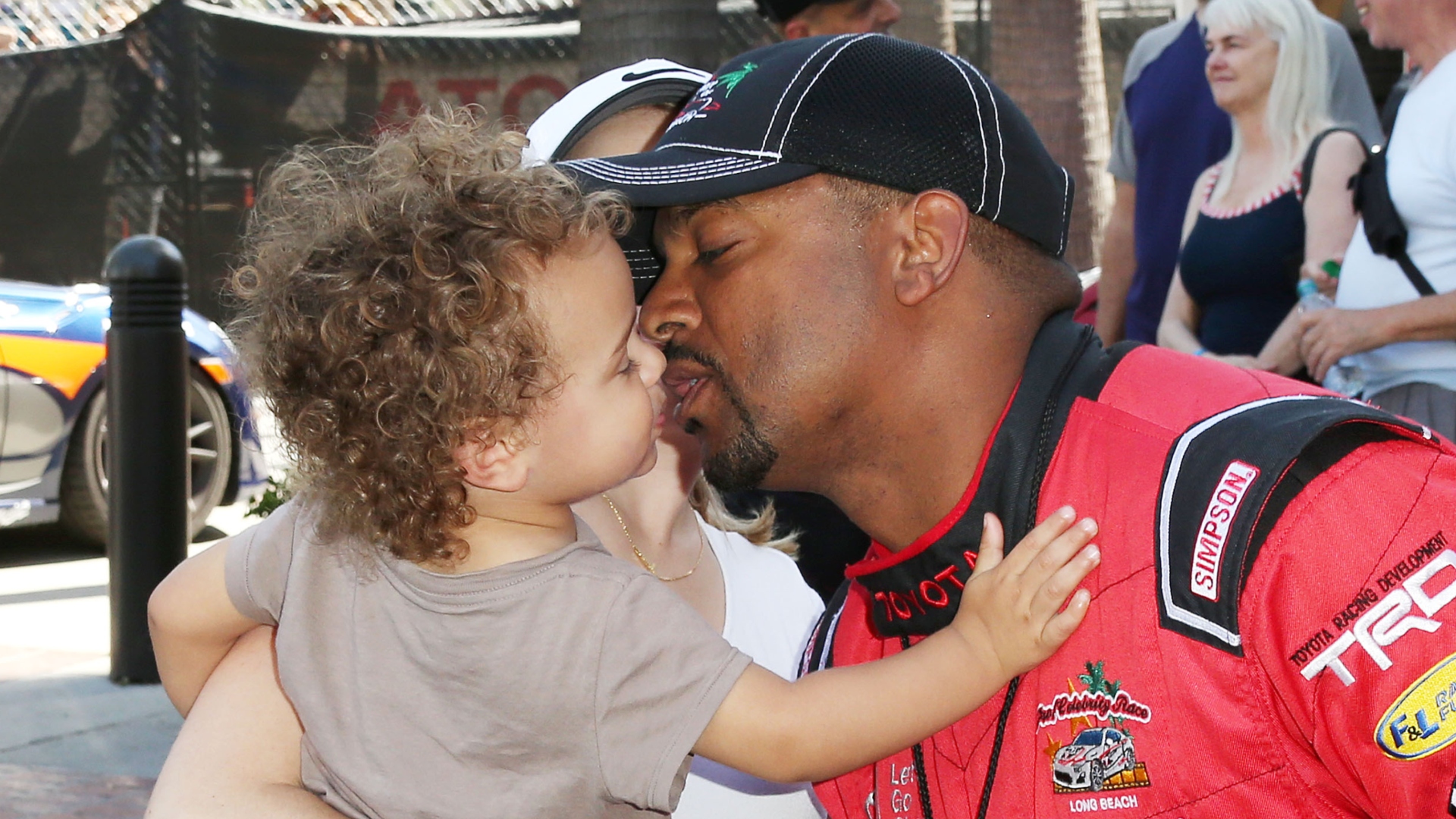 Alfonso Ribeiro kissing his young son