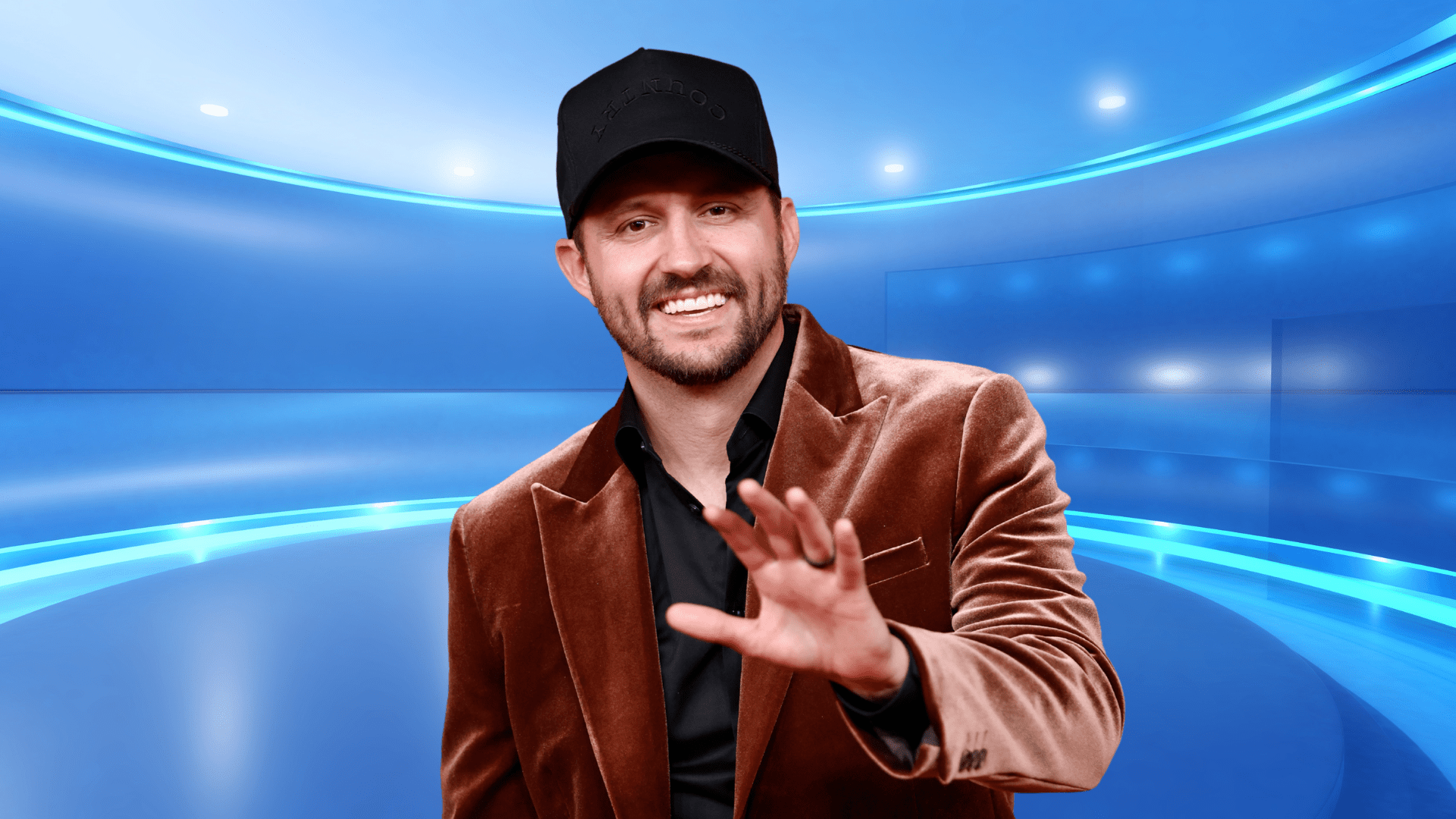 Drew Baldridge smiling in a velvet blazer