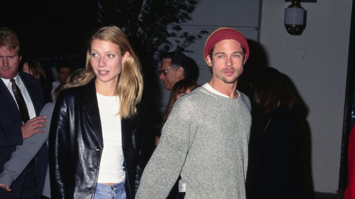 Gwyneth Paltrow, wearing a black leather jacket over a white t-shirt with jeans, and her partner, American actor Brad Pitt