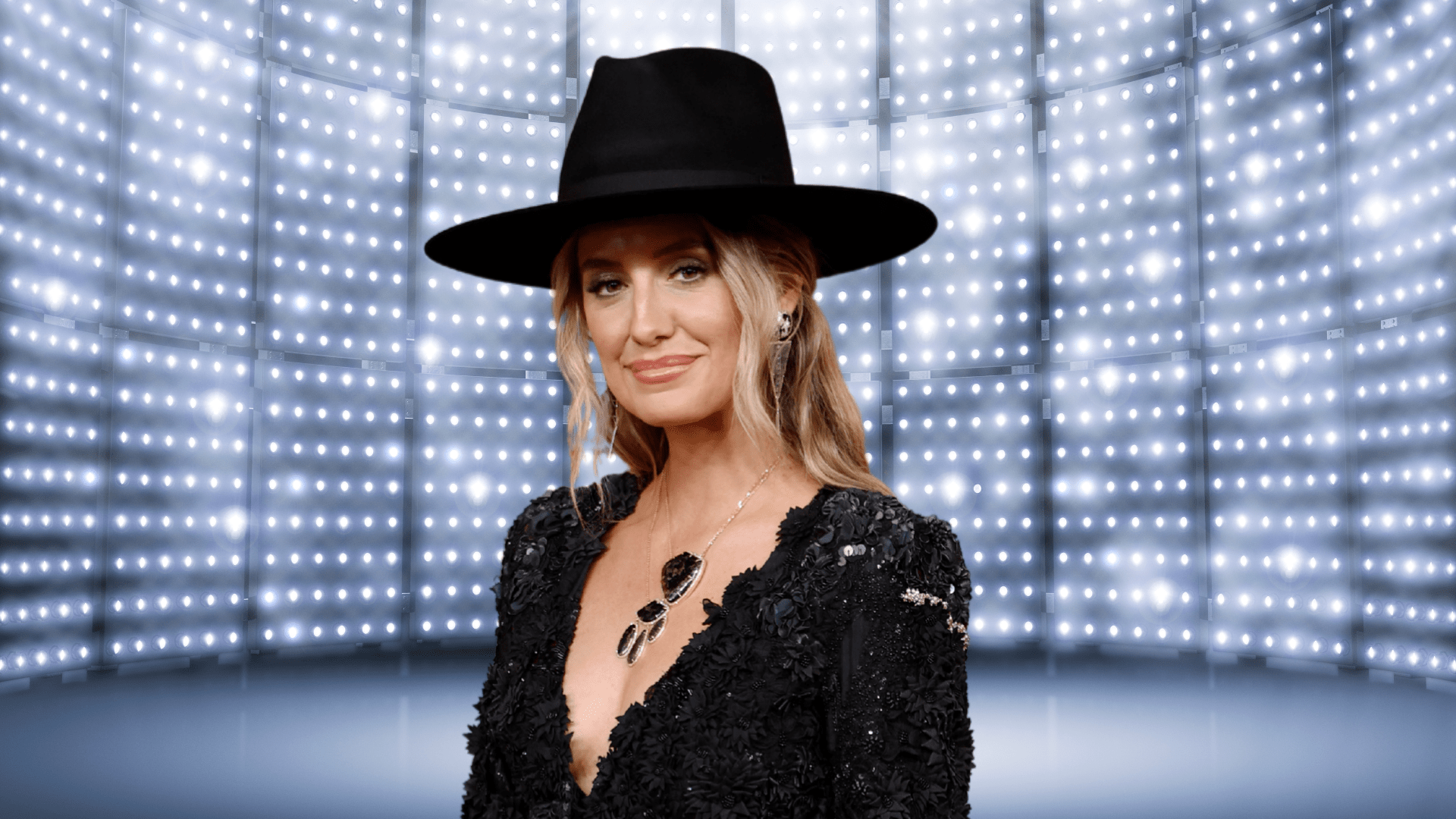 Lainey Wilson posing in an all-black outfit