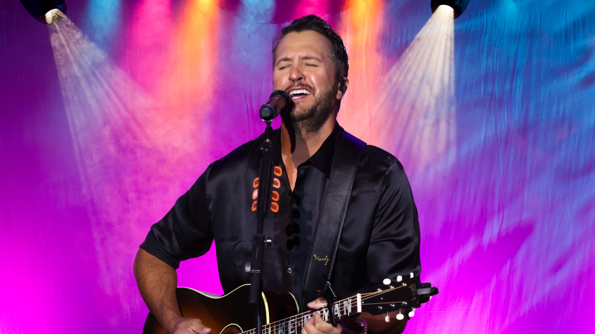 Luke Bryan singing and playing guitar