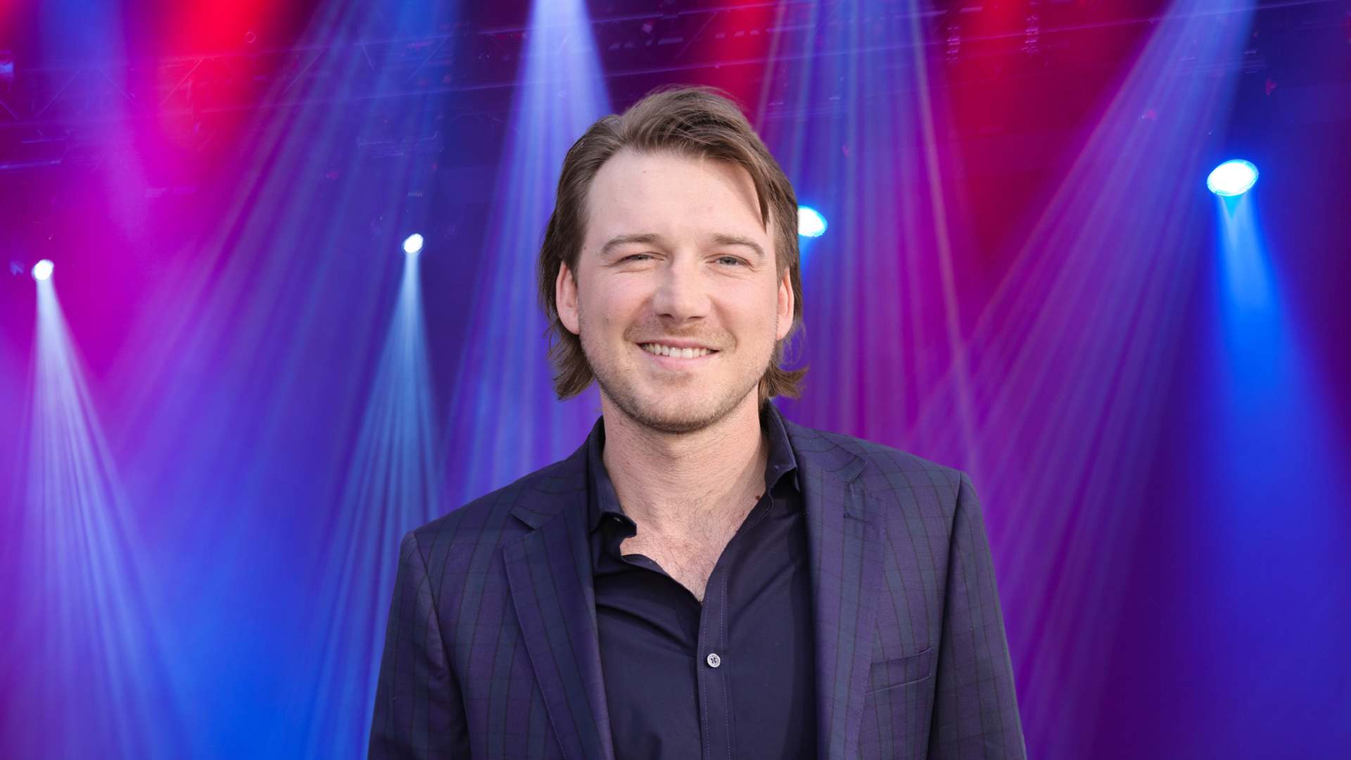 Morgan Wallen posing on a stage