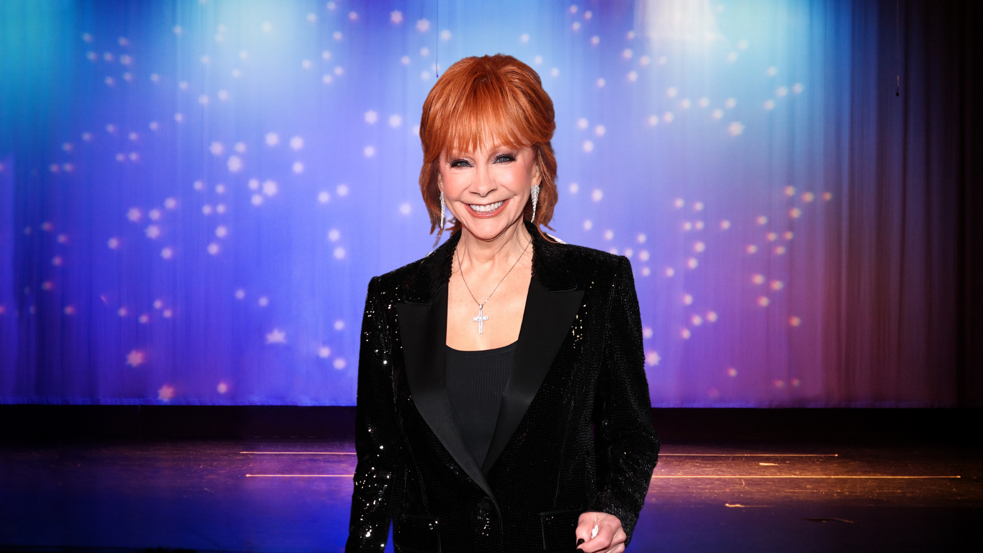 Reba McEntire smiling on a stage