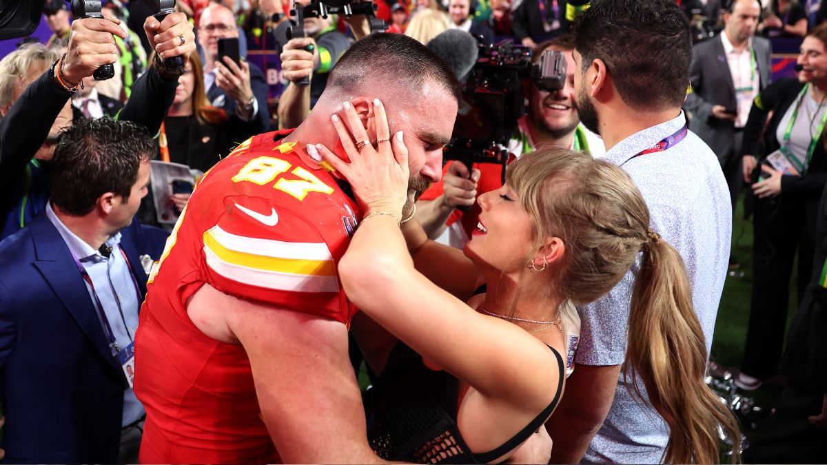 Travis Kelce #87 of the Kansas City Chiefs celebrates with Taylor Swift after defeating the San Francisco 49ers 25-22 in overtime during Super Bowl LVIII