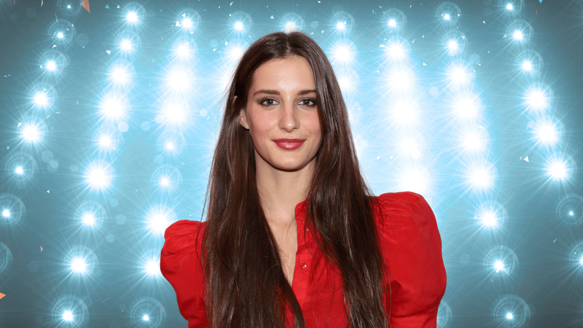 Audrey McGraw posing in front of colorful lights.