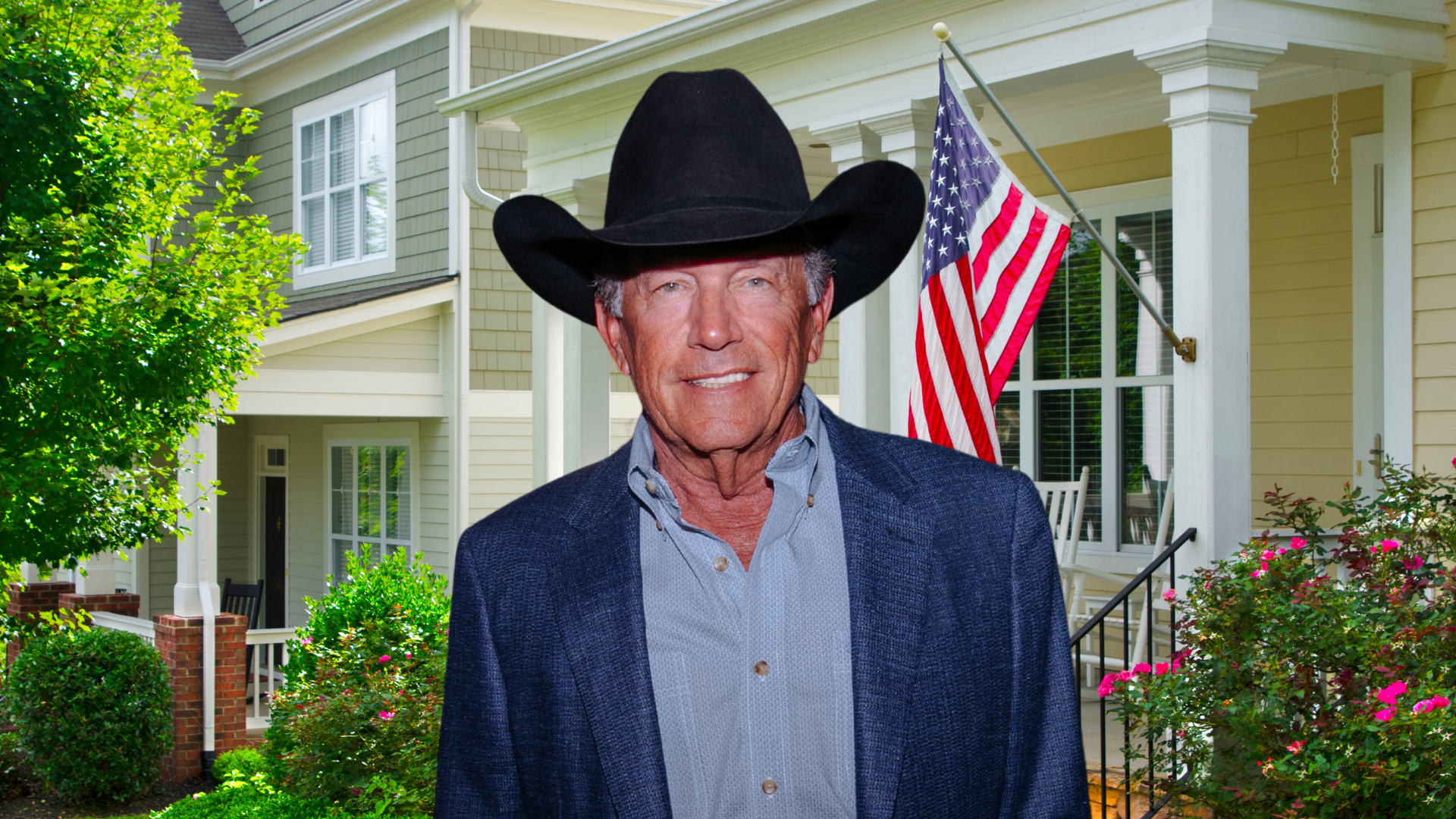 George Strait smiling in front of a house