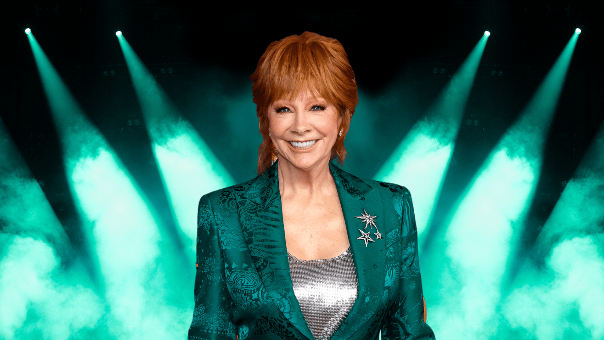 Reba McEntire smiling in a green jacket