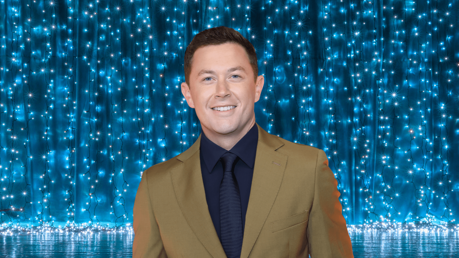 Scotty McCreery posing on a colorful stage