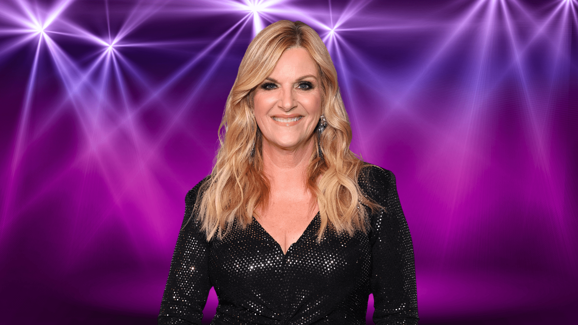 Trisha Yearwood smiling in front of colorful lights
