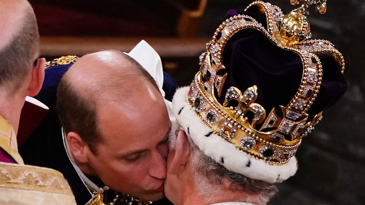 Britain's Prince William, Prince of Wales kisses his father, Britain's King Charles III, wearing St Edward's Crown, during the King's Coronation Ceremony inside Westminster Abbey