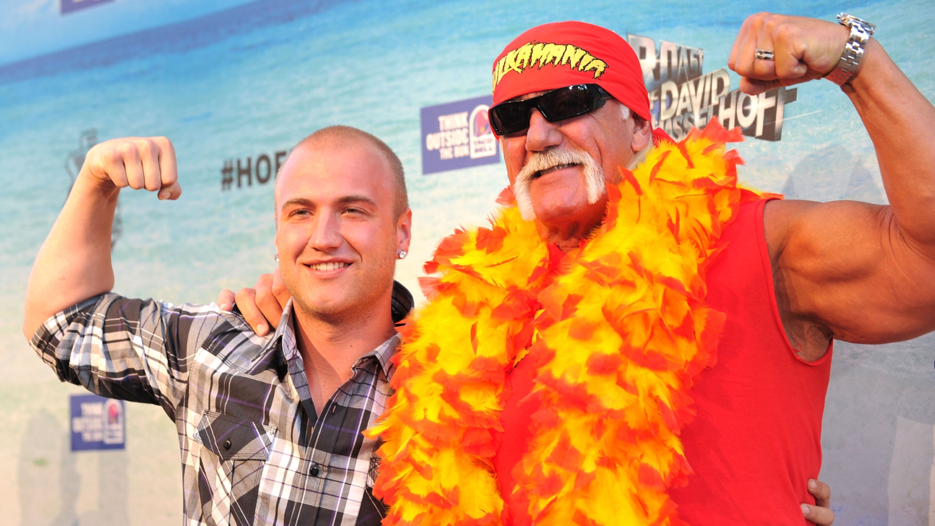 Hulk Hogan and son Nick Hogan smiling and posing