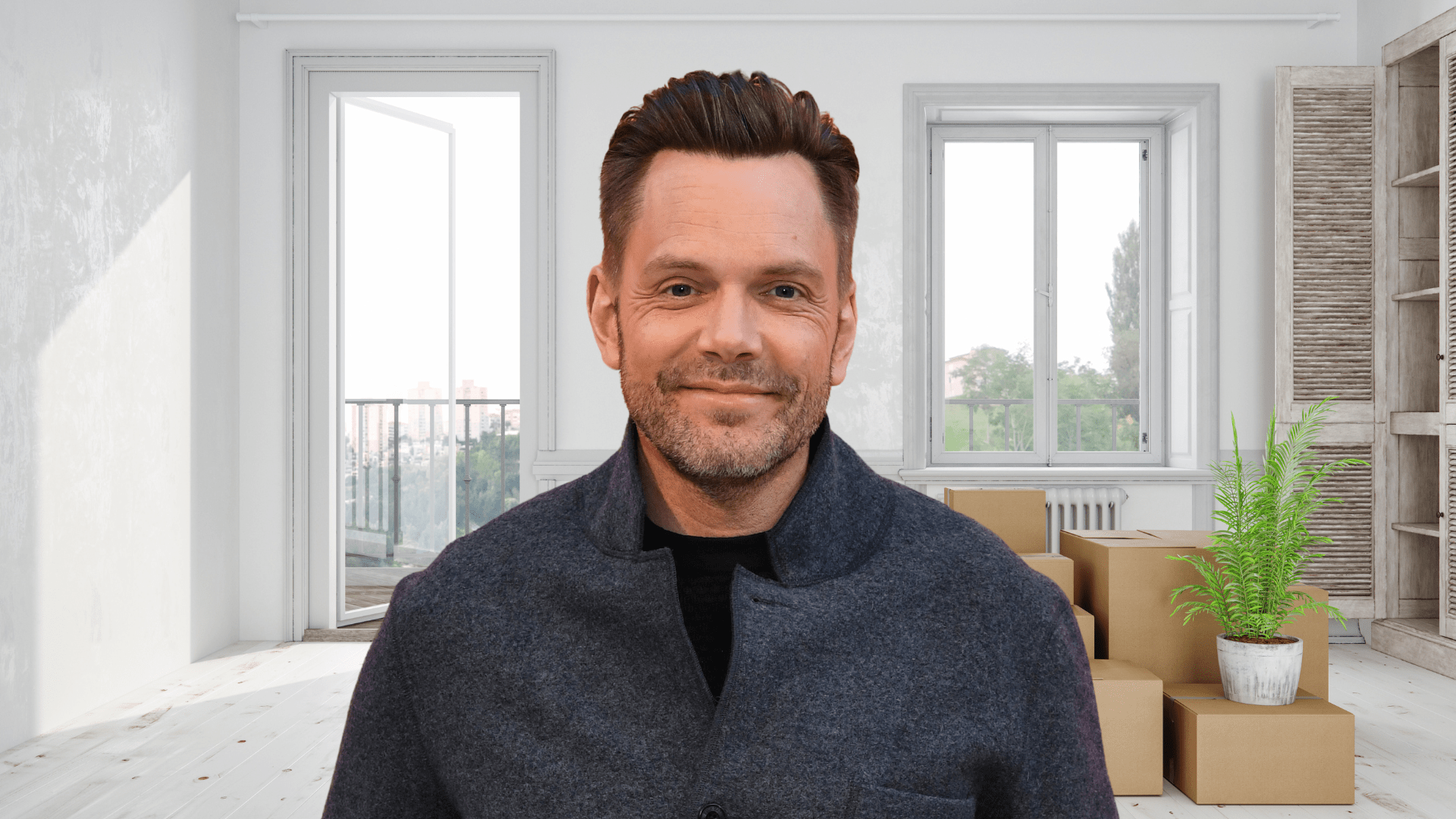 Joel McHale smiling in a house.