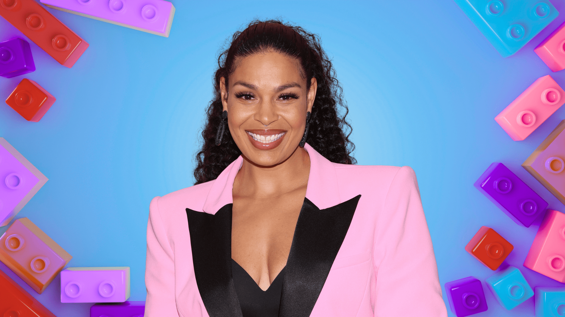 Jordin Sparks smiling in a pink blazer.