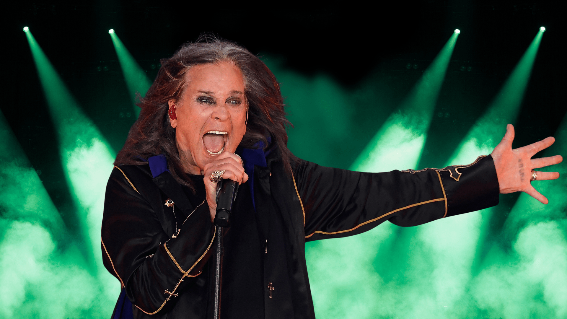 Ozzy Osbourne singing on stage.