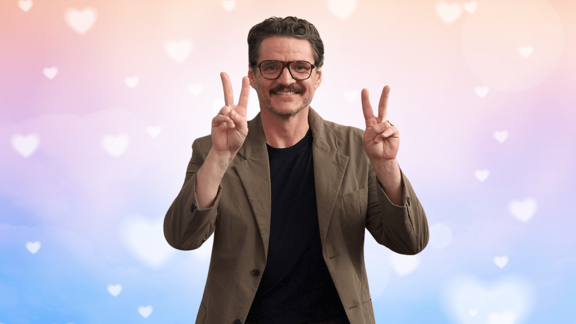 Pedro Pascal in front of a multi-colored hearts background