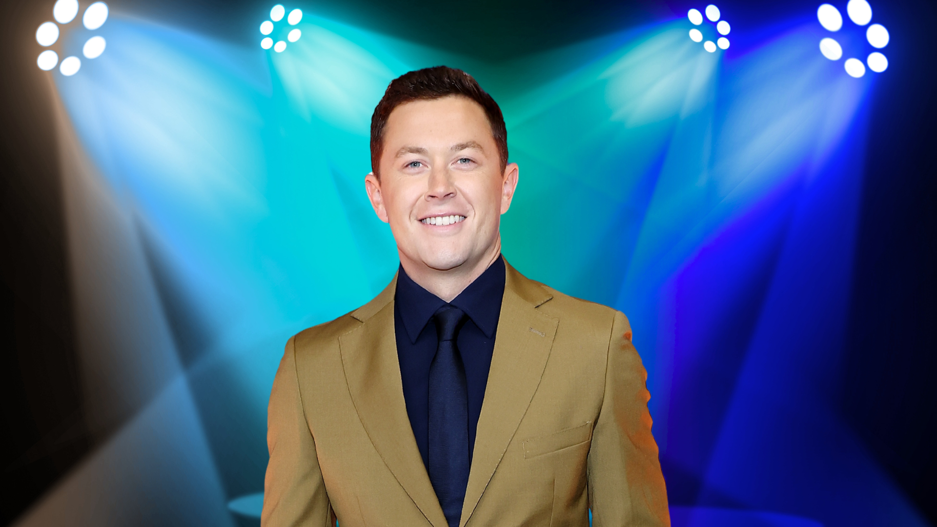 Scotty McCreery posing in a tan suit