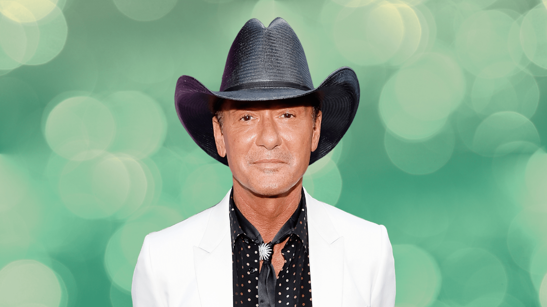 Tim McGraw posing in a black cowboy hat