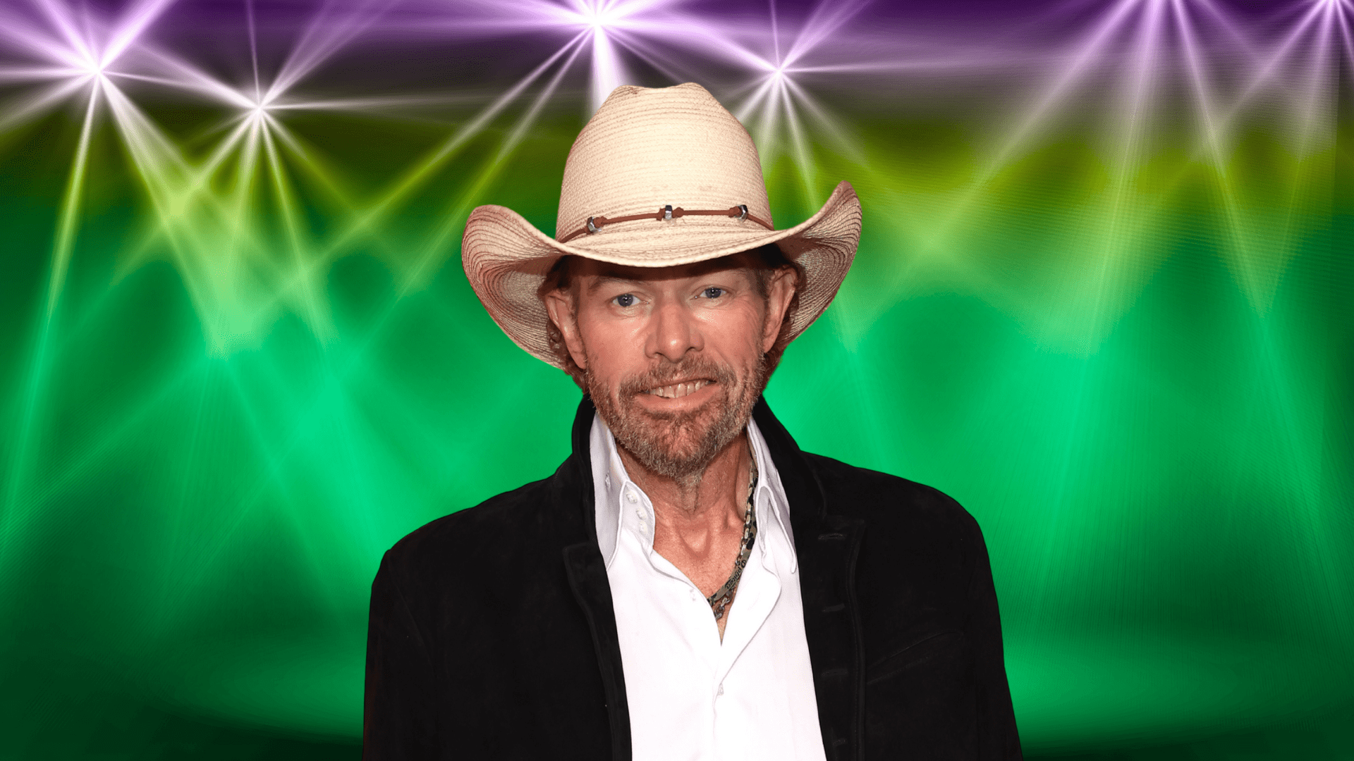 Toby Keith posing on a colorful stage.