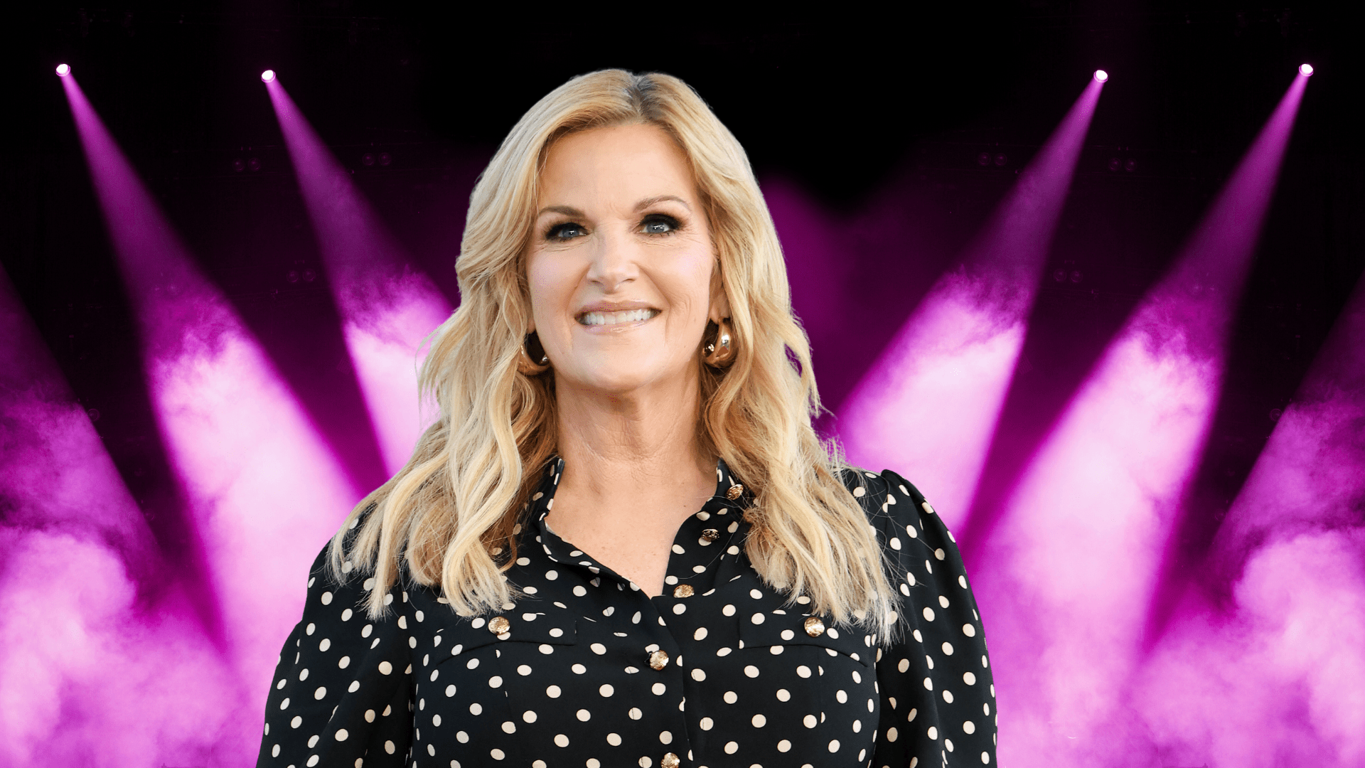Trisha Yearwood smiling in a polka dot outfit.