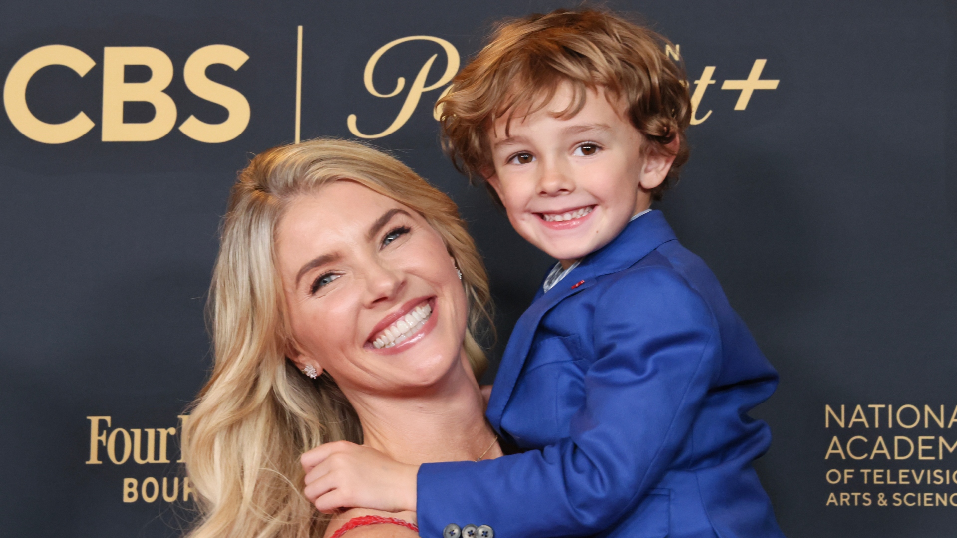 Amanda Kloots and her son Elvis Cordero smiling at an event