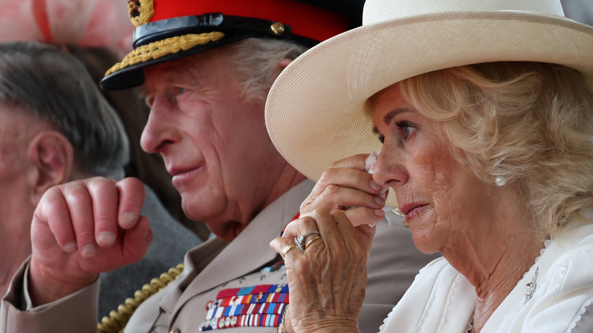 Britain's King Charles and Queen Camilla wipes away tears