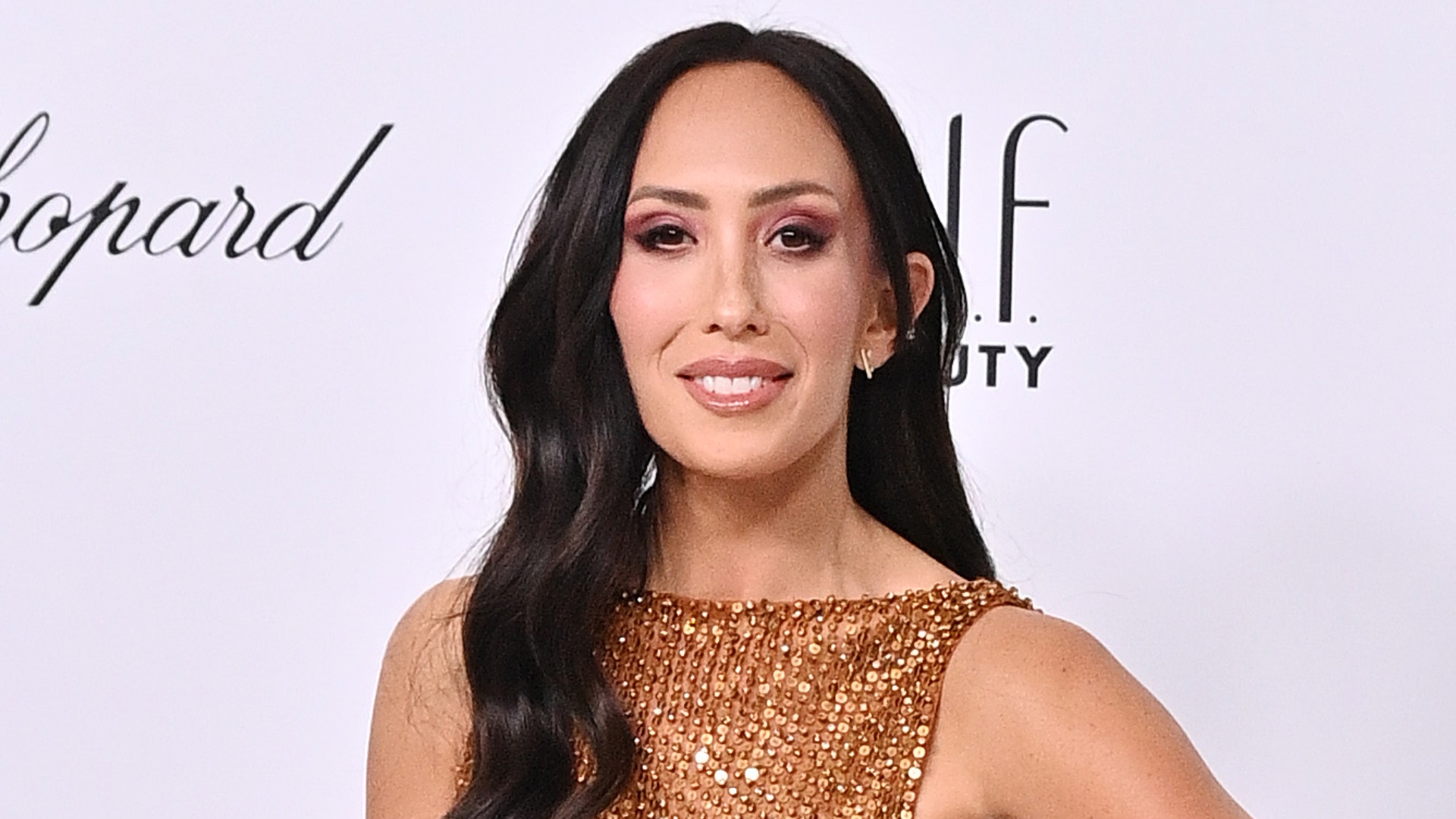 Cheryl Burke smiling at an event