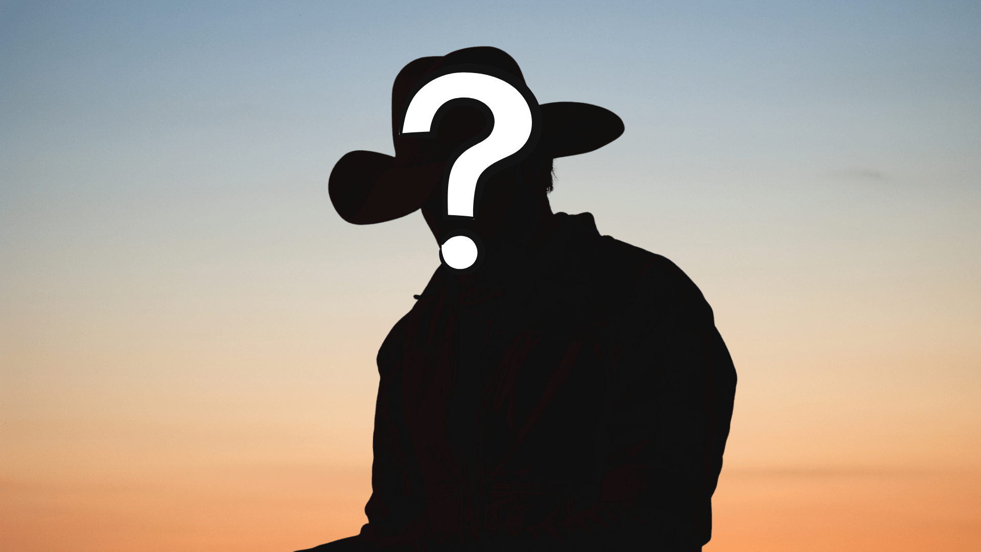 A silhouette of a cowboy against a sunset