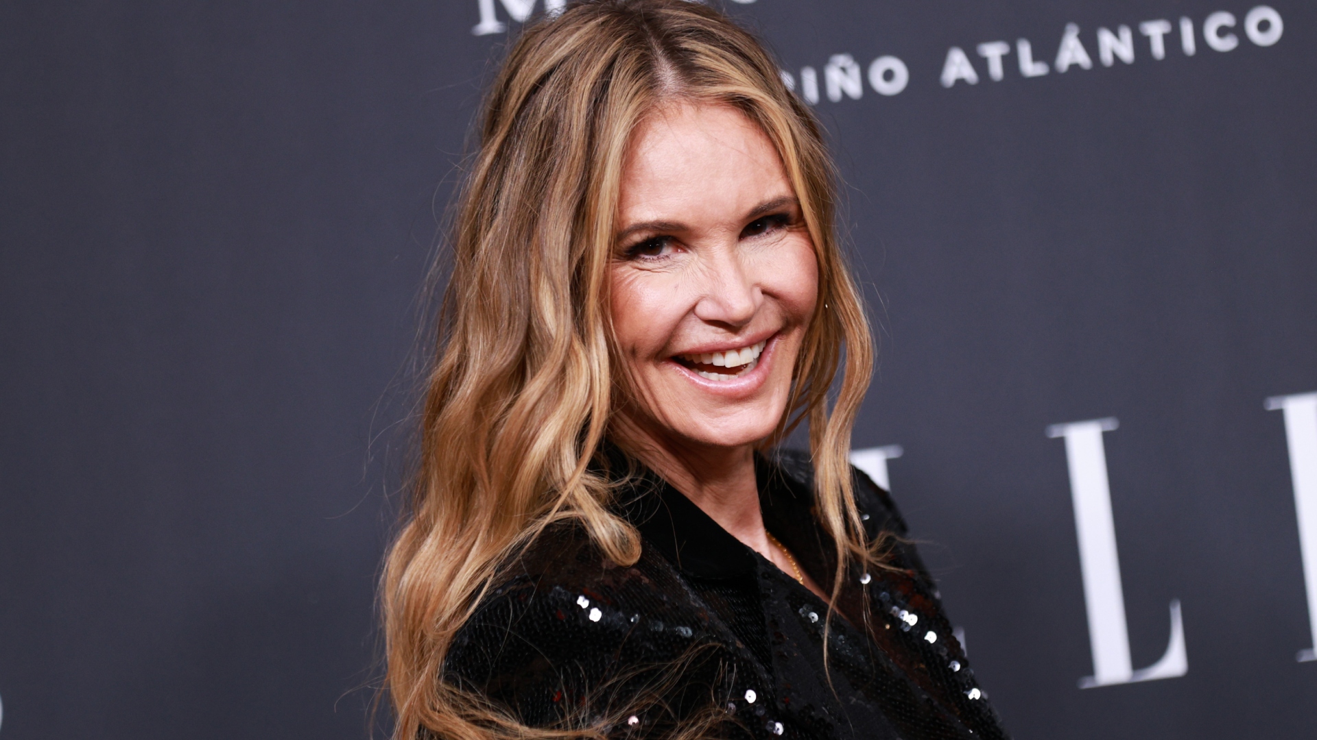 Elle Macpherson smiling at an event