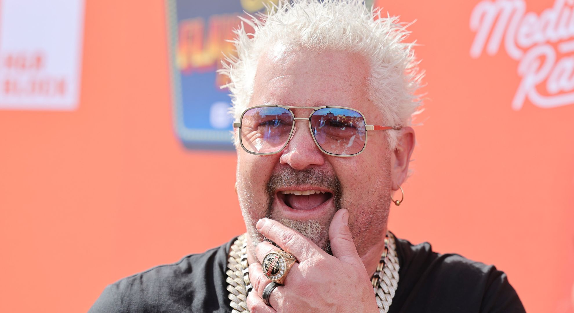 Guy Fieri is interviewed at Guy Fieri's Flavortown Tailgate on February 12, 2023