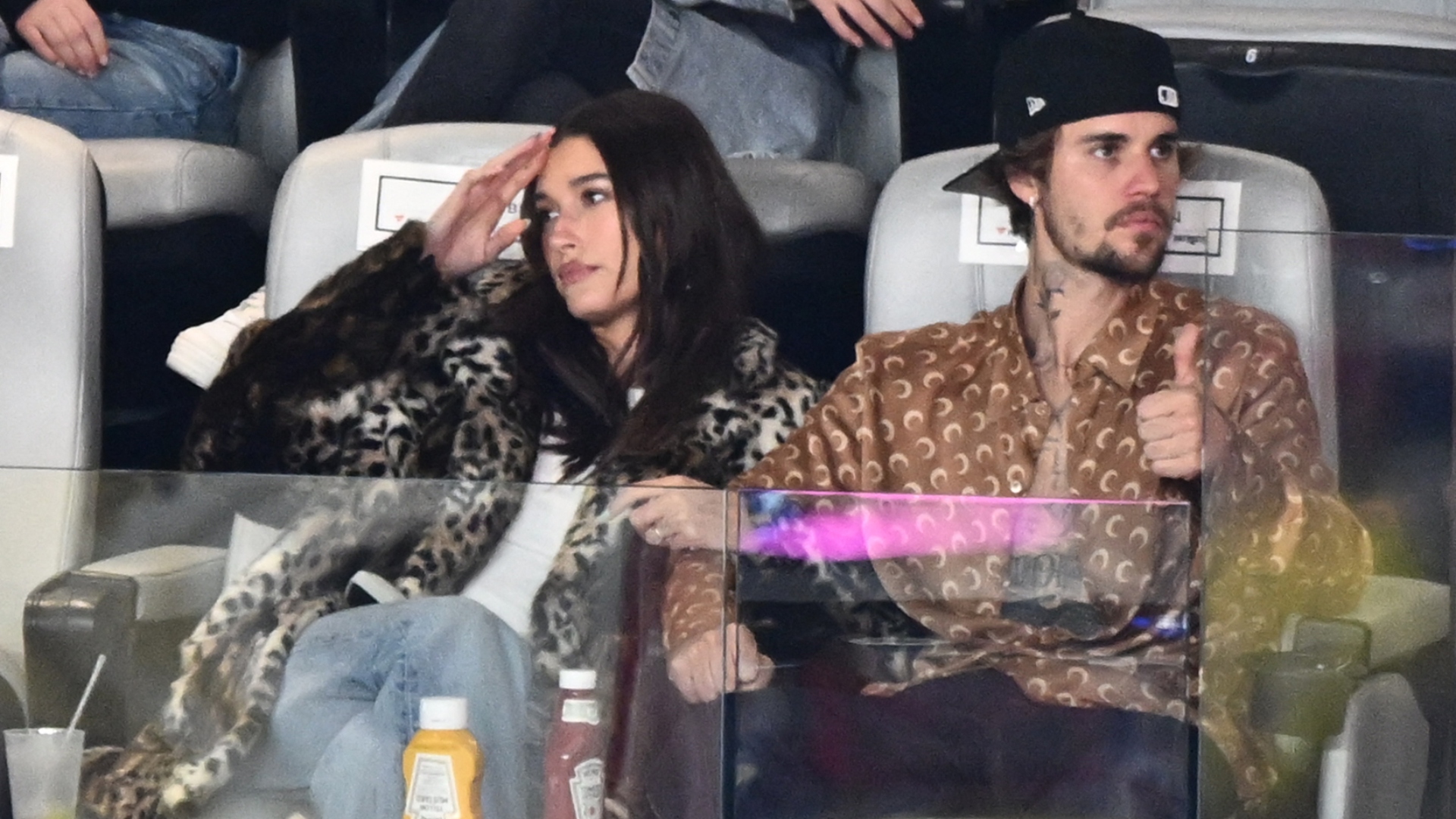 Justin Bieber and Hailey Bieber watch a Super Bowl game