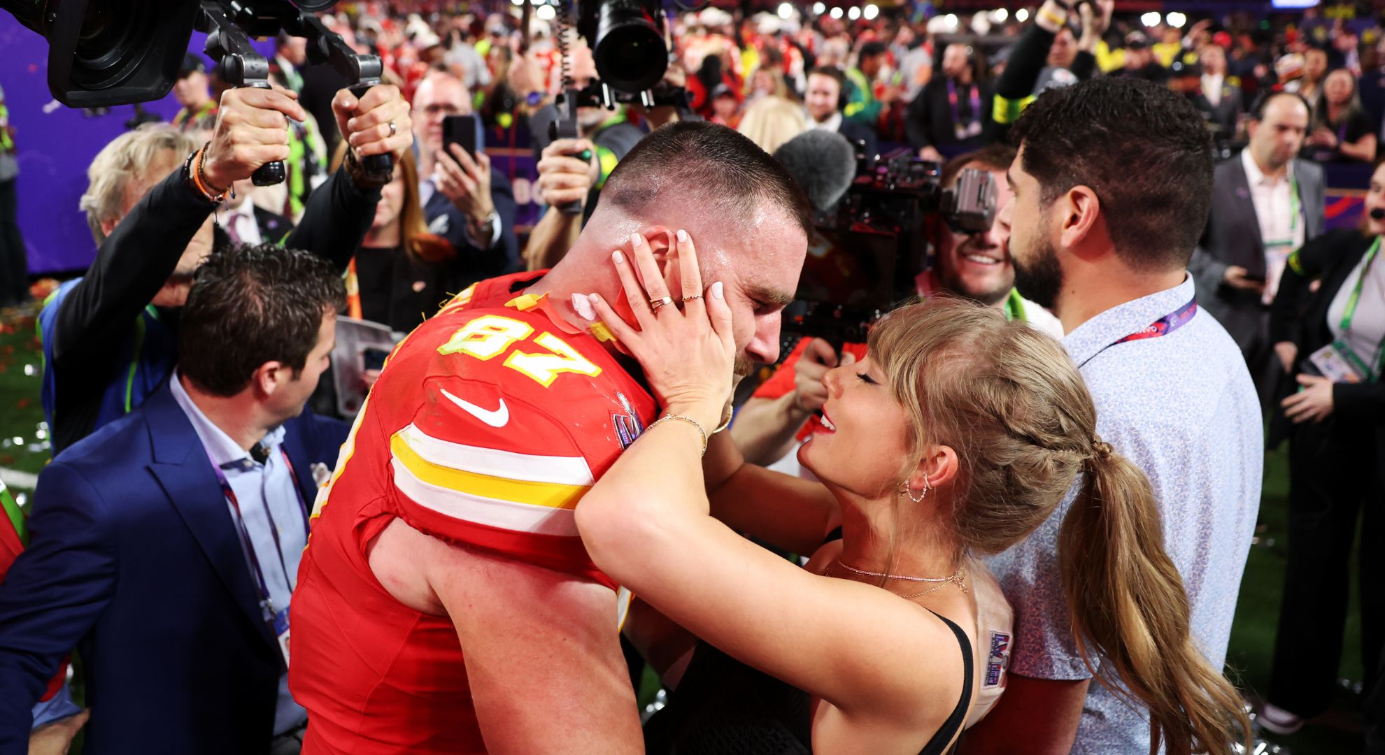 Travis Kelce #87 of the Kansas City Chiefs and Taylor Swift embrace after defeating the San Francisco 49ers 25-22 in overtime during Super Bowl LVIII