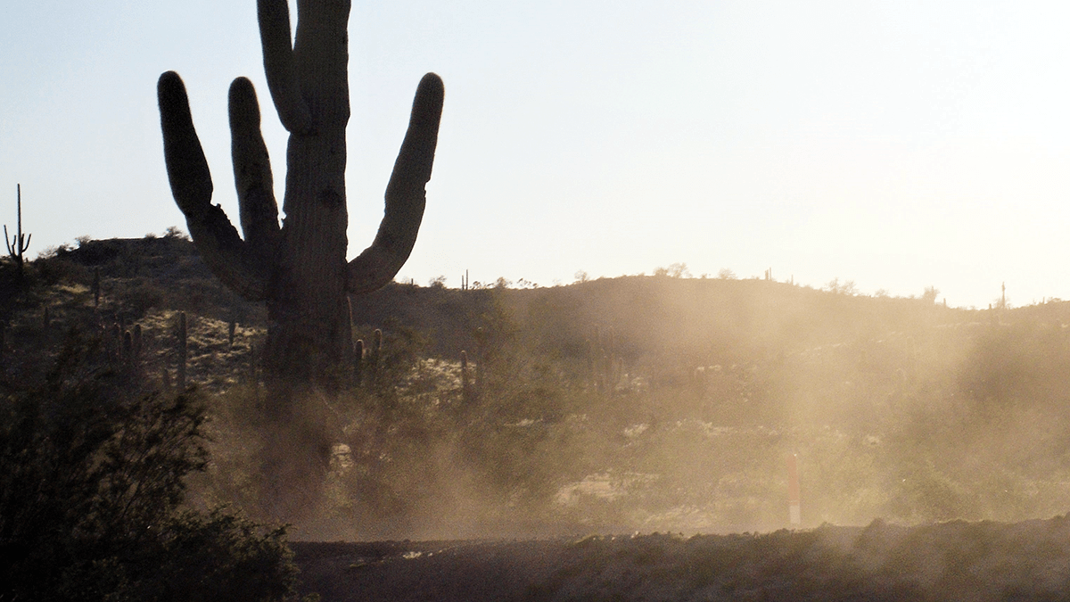 Photo of dust blowing on an Arizona hillside.