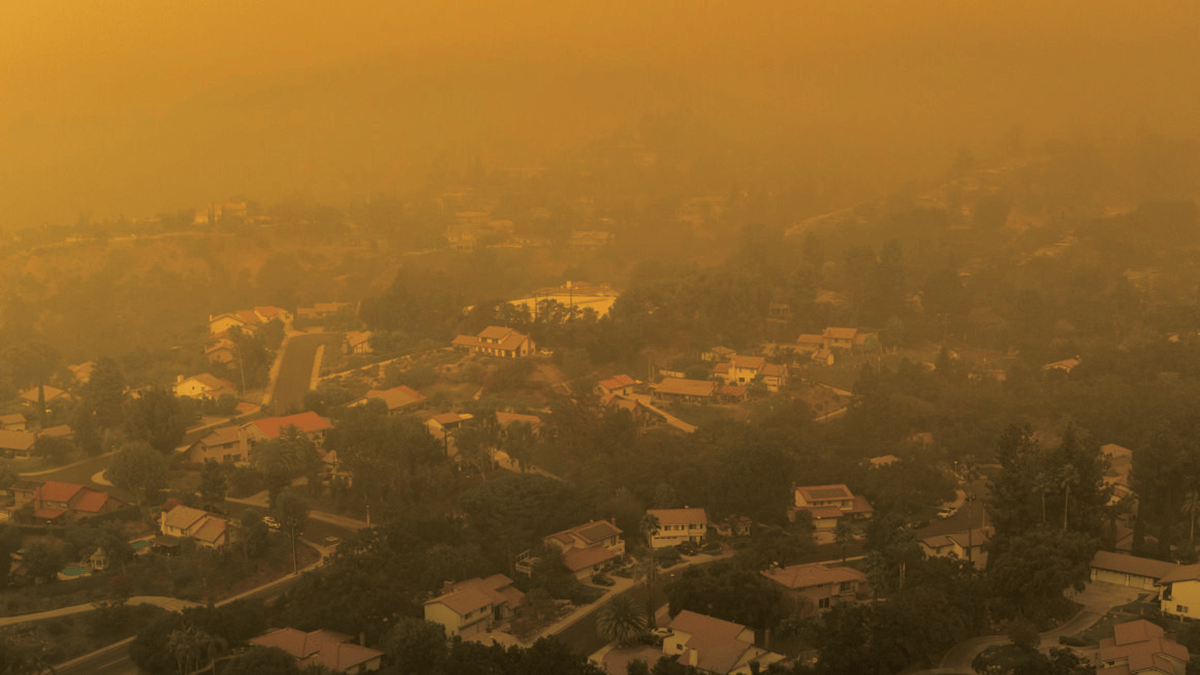 A neighborhood covered in thick, orange smoke.