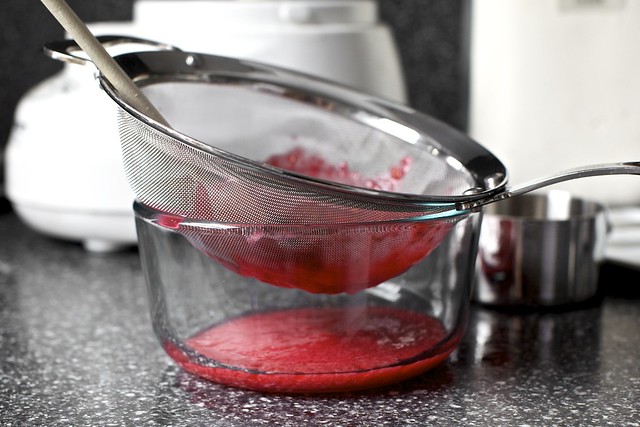 pressing out the raspberry seeds
