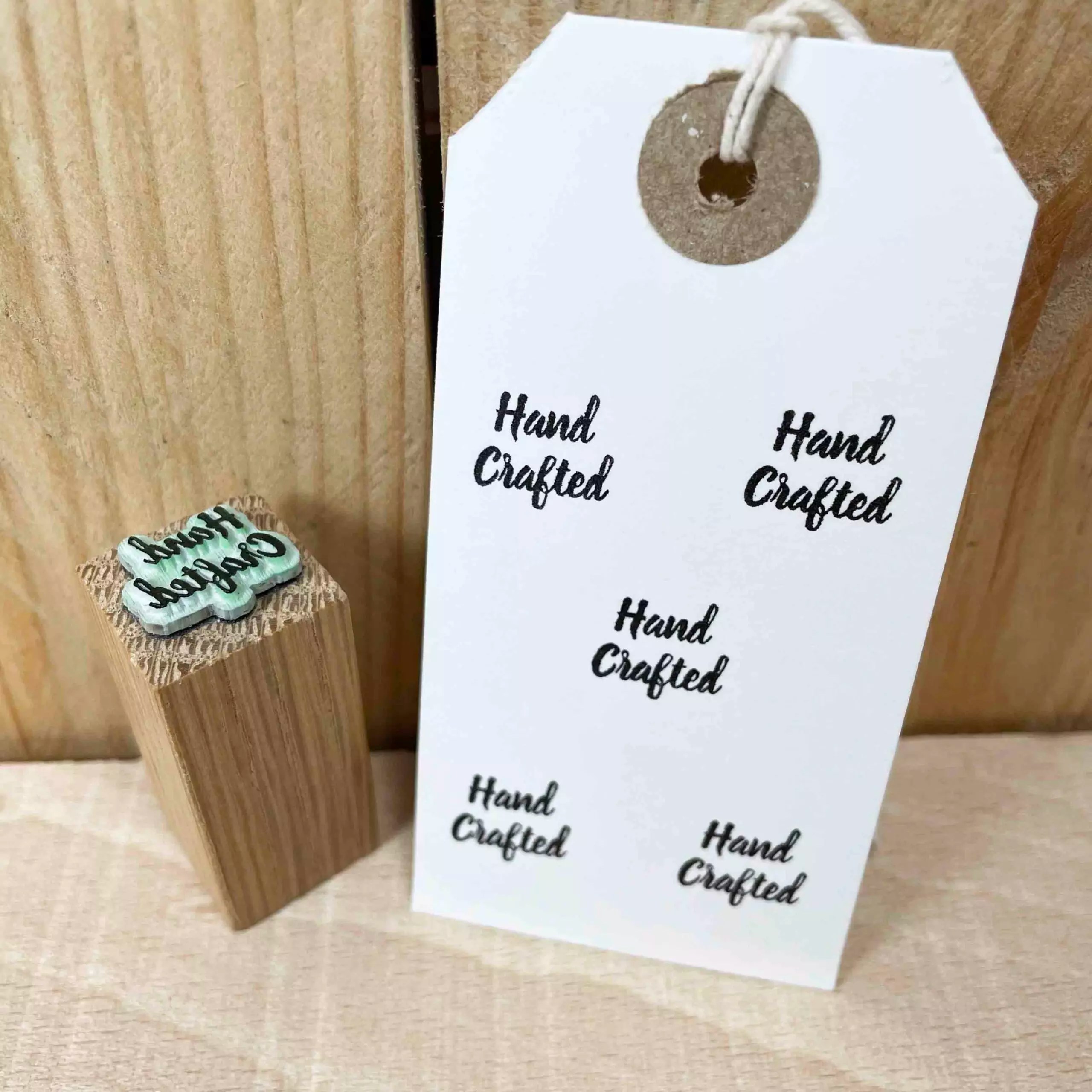 mini rubber stamp that reads "hand crafted" in a cursive font