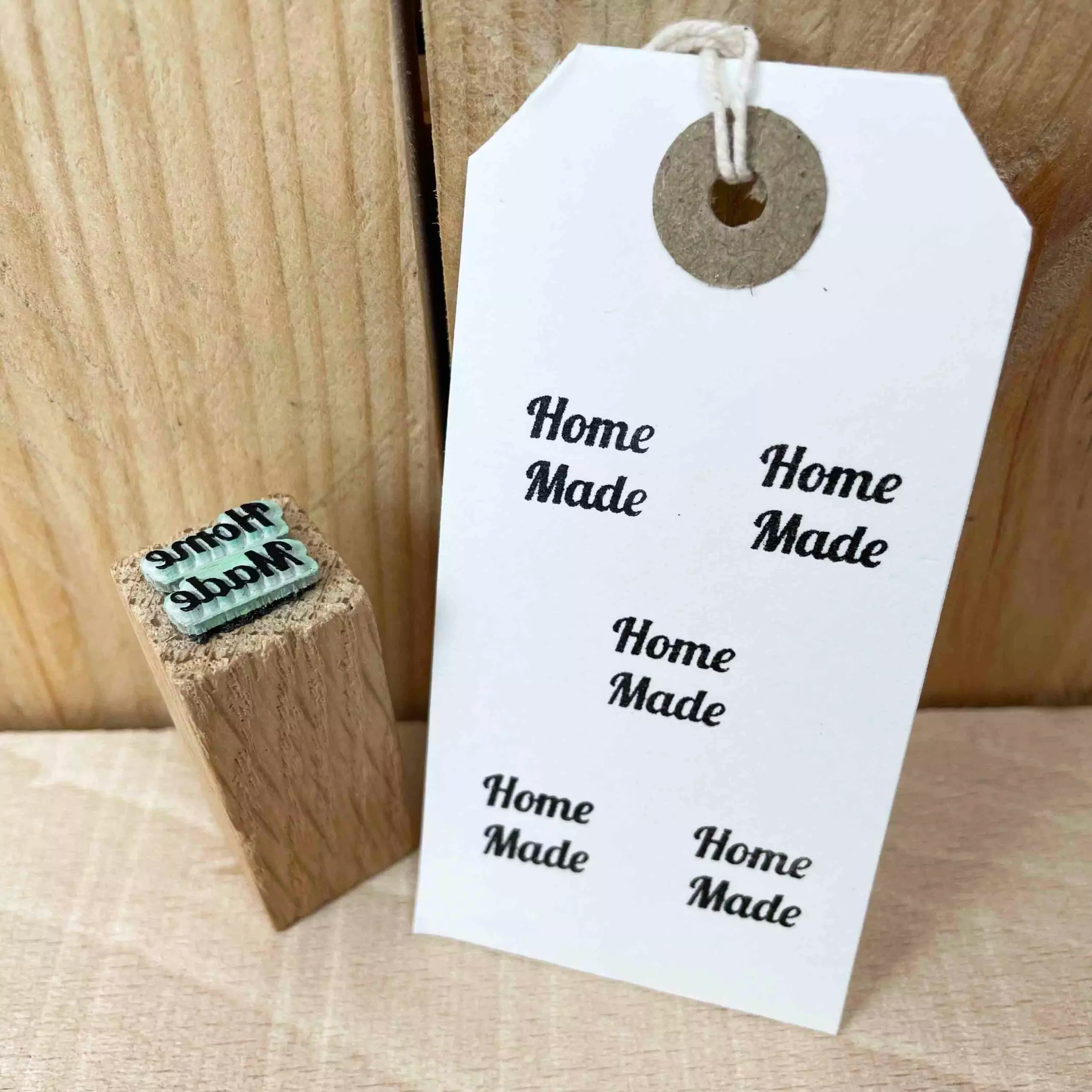 small rubber stamp made from green rubber and oak that reads 'home made'