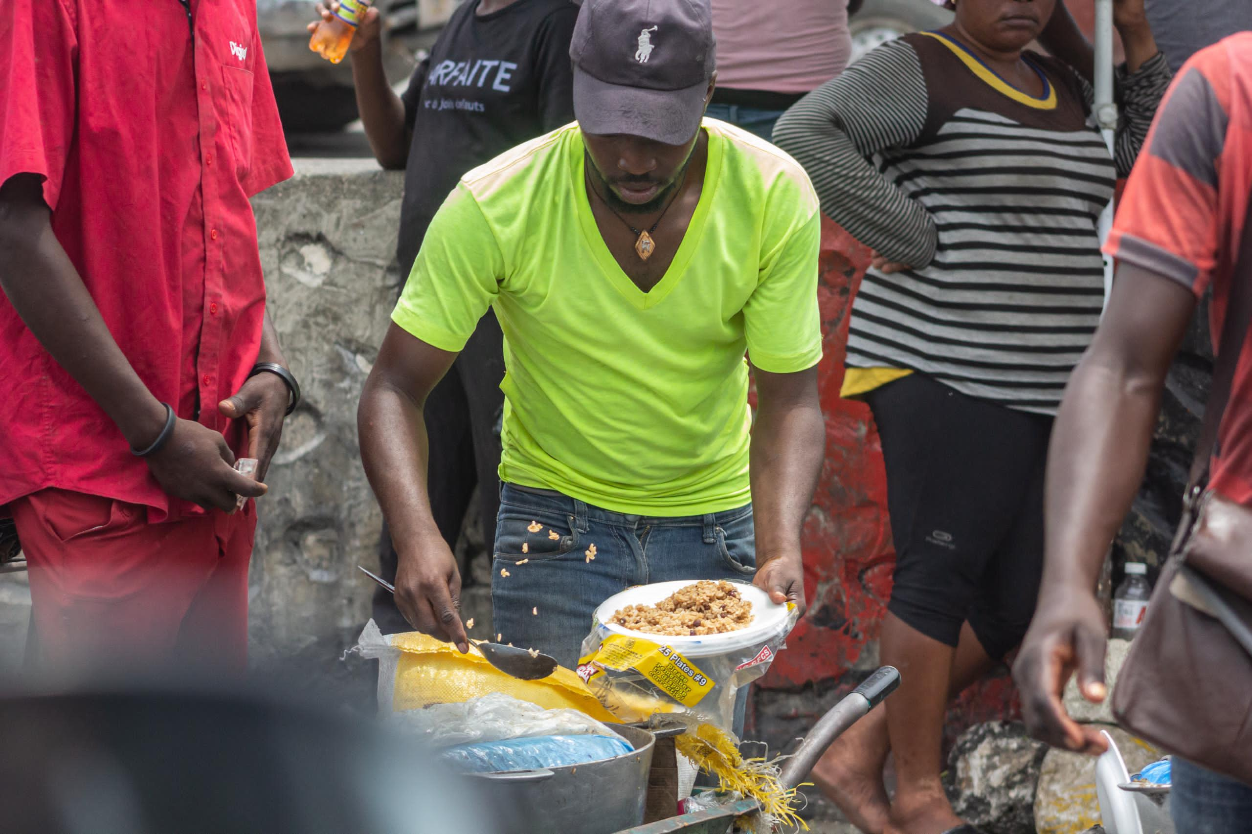 Gangs’ grip on Haitian capital spurs new kind of street vendor: Men selling cooked rice